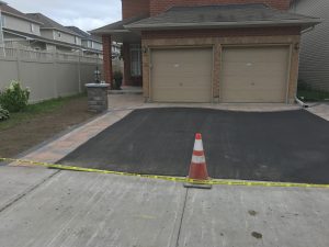 paved driveway also widened on both sides with pylon and caution tape